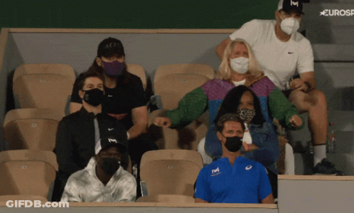 A Group Of People Wearing Face Masks Are Sitting In A Stadium With A Eurosport Logo Behind Them GIF