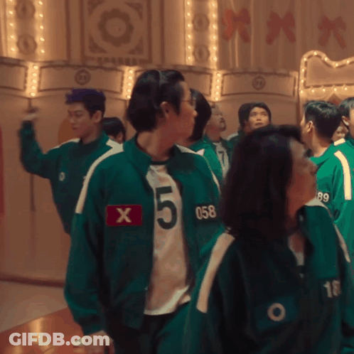 A Group Of People Wearing Green Jackets With The Number 5 On The Front GIF