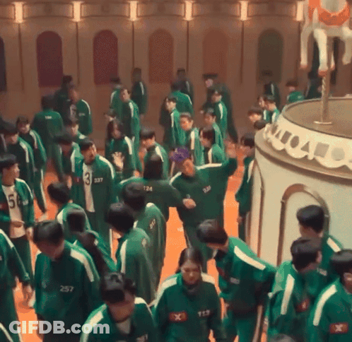 A Group Of People Wearing Green Uniforms With Numbers On Them GIF