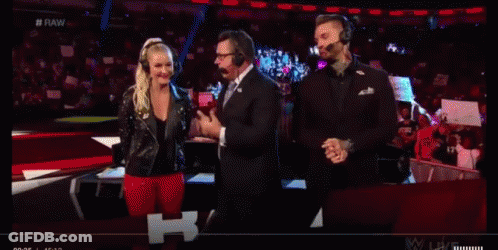 A Group Of People Wearing Headphones Are Standing In Front Of A Crowd On A Stage . GIF