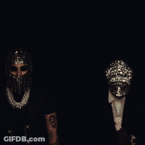 A Group Of People Wearing Masks Are Standing Around A Couch GIF