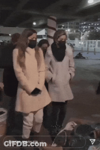 A Group Of People Wearing Masks Are Standing In Front Of A Sign That Says Enviar Mensaje GIF