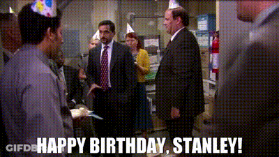 A Group Of People Wearing Party Hats Are Standing In A Room With The Words Happy Birthday Stanley . GIF