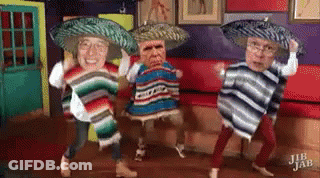 A Group Of People Wearing Sombrero 'S And Ponchos Are Dancing In A Room . GIF