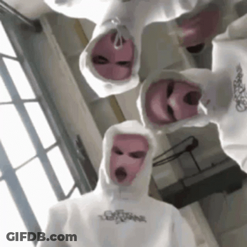 A Group Of People Wearing White Hoodies And Pink Ski Masks . GIF