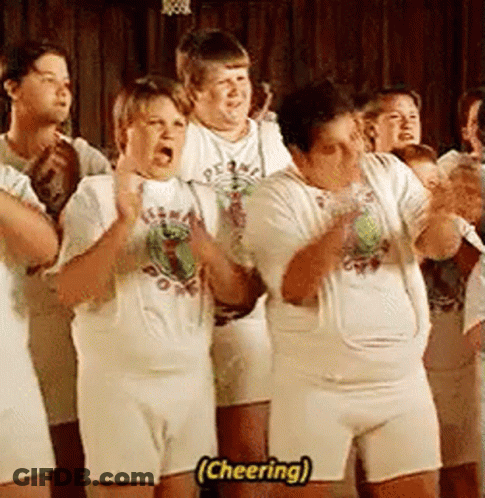 A Group Of People Wearing White Shirts And Shorts Are Standing In A Line And Cheering . GIF