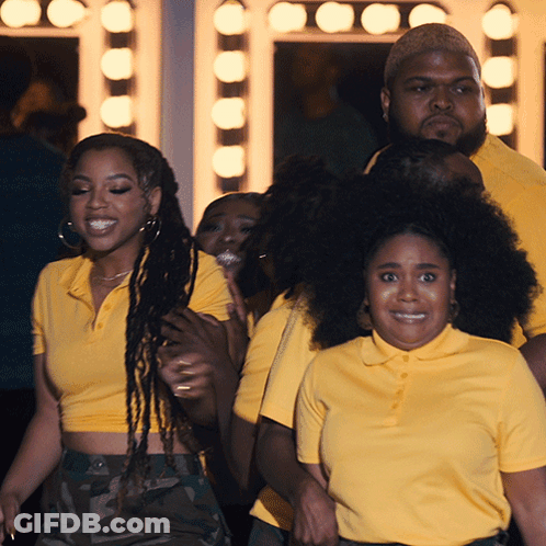 A Group Of People Wearing Yellow Shirts Are Standing Together GIF