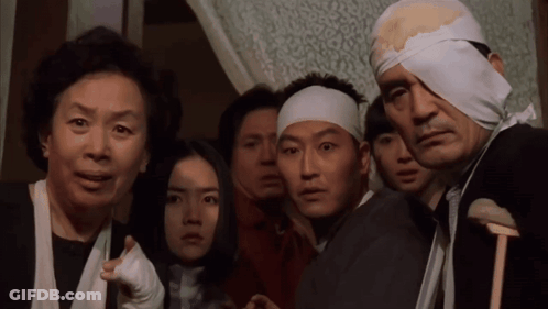 A Group Of People With Bandages On Their Heads Are Looking At Something GIF