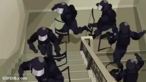 A Group Of Police Officers Are Running Down The Stairs . GIF