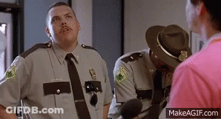 A Group Of Police Officers Are Standing Next To Each Other And Talking To Each Other . GIF