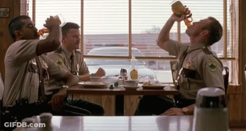 A Group Of Police Officers Drinking Beer At A Diner GIF
