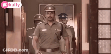 A Group Of Police Officers Walking Down A Hallway . GIF