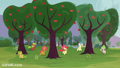 A Group Of Ponies Are Standing Around Trees In A Field GIF