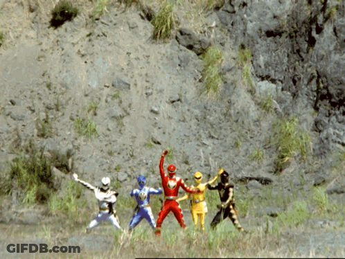 A Group Of Power Rangers Are Standing In A Field With A Mountain In The Background GIF