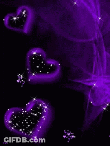 A Group Of Purple Hearts Are Floating In The Air On A Black Background . GIF
