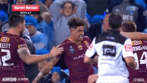 A Group Of Rugby Players Are Hugging Each Other And One Of Them Has The Number 14 On His Shirt GIF