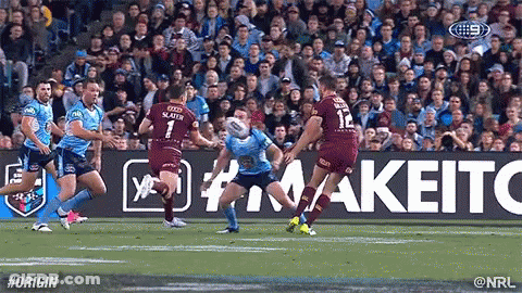 A Group Of Rugby Players Are Playing A Game Of Rugby In Front Of A Crowd . GIF