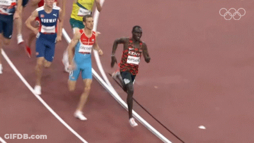 A Group Of Runners Are Running On A Track And One Of Them Is Wearing A Kenya Shirt GIF