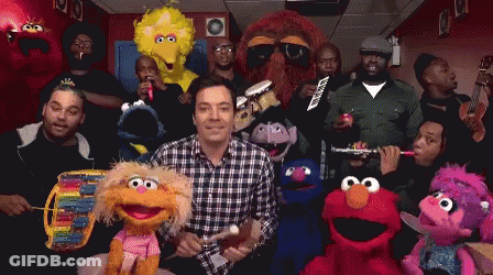 A Group Of Sesame Street Characters Are Posing For A Photo With Jimmy Fallon GIF