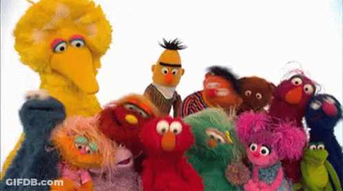 A Group Of Sesame Street Characters Standing Next To Each Other . GIF