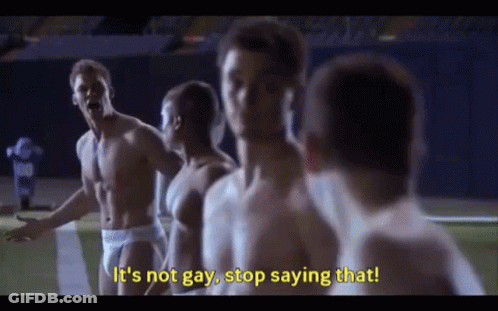 A Group Of Shirtless Men Are Standing On A Football Field And One Of Them Is Saying It 'S Not Gay , Stop Saying That GIF
