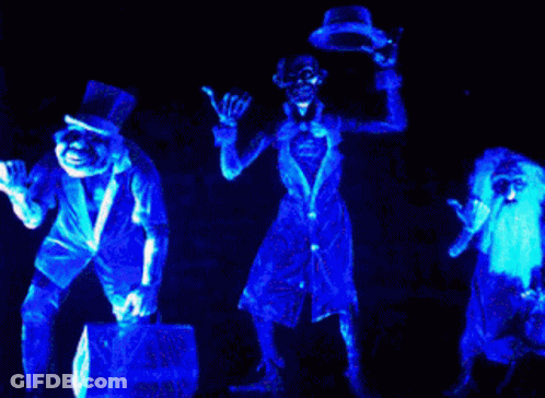 A Group Of Skeletons Are Glowing In Blue Light GIF