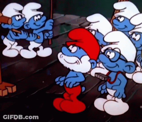 A Group Of Smurfs Standing On A Wooden Floor GIF