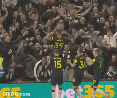 A Group Of Soccer Players Are Celebrating A Goal And One Of Them Has The Number 15 On His Back GIF