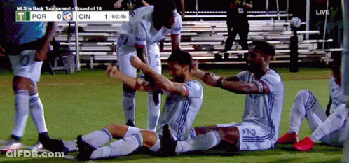 A Group Of Soccer Players Are Celebrating A Goal During A Game Between Por And Cin GIF