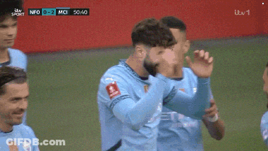 A Group Of Soccer Players Are Celebrating A Goal During A Game Sponsored By Itv Sport GIF