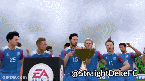 A Group Of Soccer Players Are Holding A Trophy In Front Of A Ea Sports Sign GIF