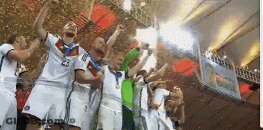 A Group Of Soccer Players Are Holding Up A Trophy And One Has The Number 23 On His Shirt GIF