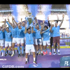 A Group Of Soccer Players Are Holding Up A Trophy In Front Of A Screen That Says Manchester City GIF