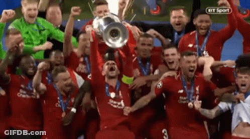 A Group Of Soccer Players Are Holding Up A Trophy In The Air GIF