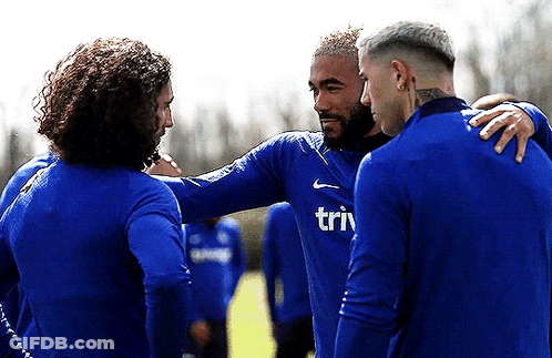 A Group Of Soccer Players Are Huddled Together And One Of Their Shirts Says Triv GIF