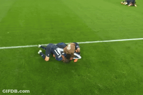 A Group Of Soccer Players Are Huddled Together On The Field And One Player Has The Number 15 On His Jersey GIF