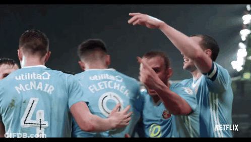A Group Of Soccer Players Are Huddled Together With One Wearing A Number 4 Jersey GIF