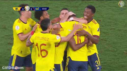 A Group Of Soccer Players Are Hugging Each Other And One Of Them Has The Number 16 On His Back GIF