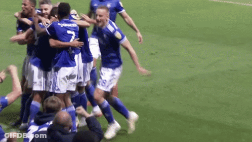 A Group Of Soccer Players Are Hugging Each Other And One Of Them Has The Number 7 On His Jersey GIF