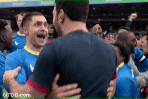 A Group Of Soccer Players Are Hugging Each Other GIF