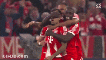 A Group Of Soccer Players Are Hugging Each Other In Front Of A Sign That Says ' Da Zn ' GIF