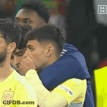 A Group Of Soccer Players Are Hugging Each Other With A Da Zn Logo In The Background GIF
