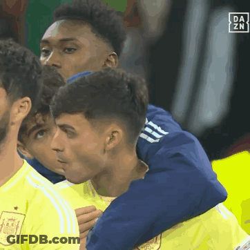 A Group Of Soccer Players Are Hugging Each Other With A Da Zn Logo In The Corner GIF