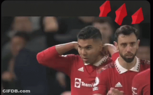 A Group Of Soccer Players Are Hugging Each Other With One Wearing A Shirt That Says ' United ' On It GIF