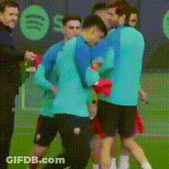 A Group Of Soccer Players Are Hugging On A Field . GIF