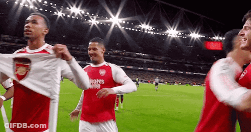 A Group Of Soccer Players Are On A Field And One Of Them Is Wearing A Shirt That Says Fly Emirates GIF