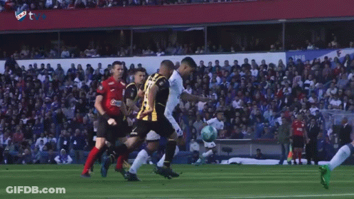 A Group Of Soccer Players Are Playing A Game In Front Of A Crowd And One Player Has The Number 9 On His Jersey GIF