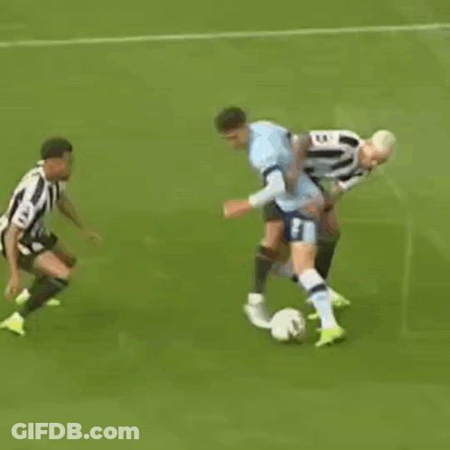 A Group Of Soccer Players Are Playing A Game Of Soccer On A Field . GIF