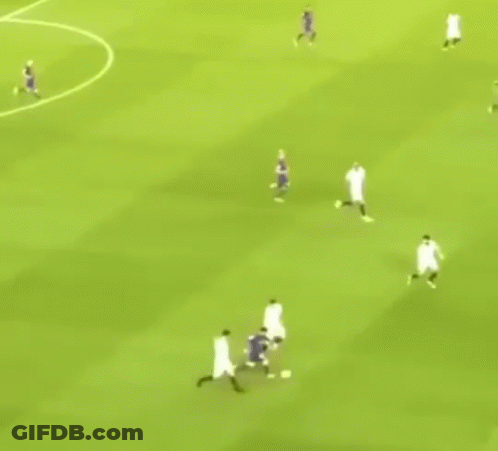 A Group Of Soccer Players Are Playing A Game On A Field . GIF