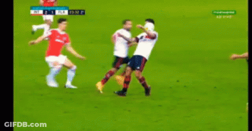 A Group Of Soccer Players Are Playing A Game On A Field . GIF